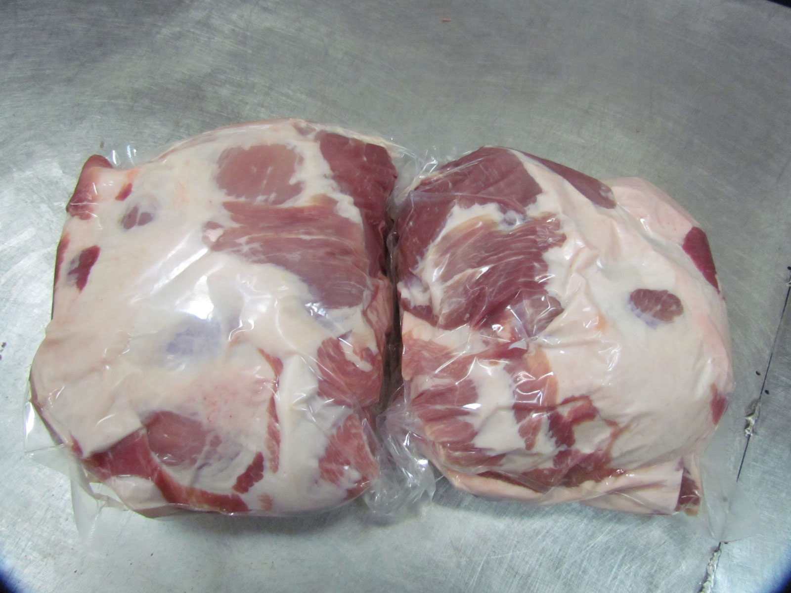 Vacuum-sealed pork shoulder pair — reefer container ready